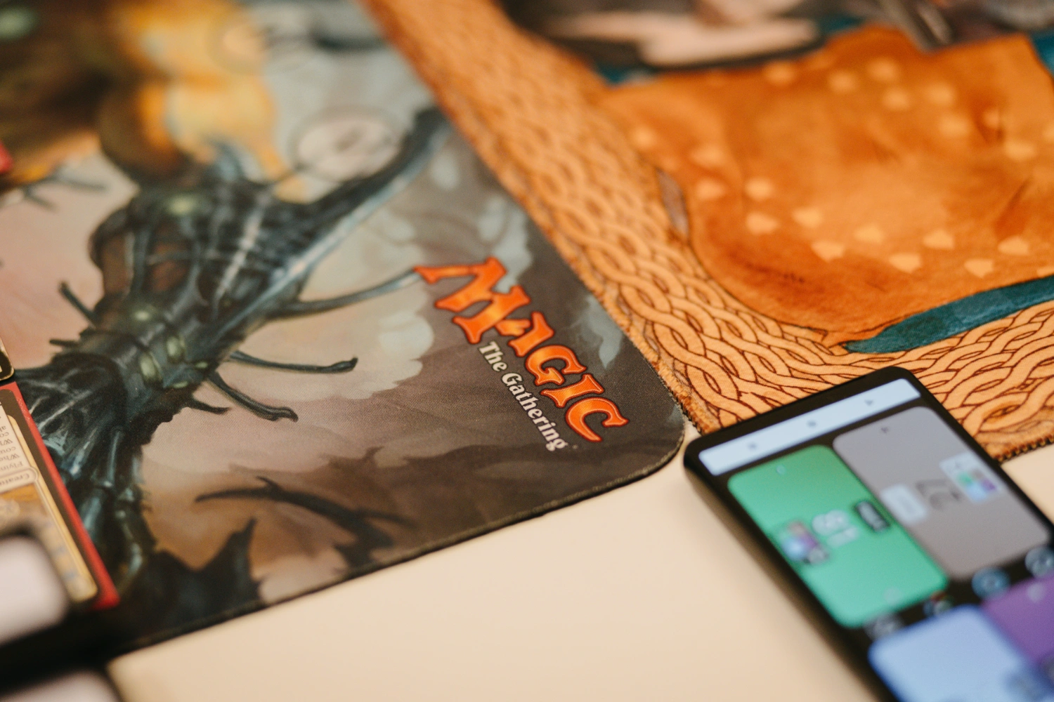 Nahaufnahme einer Spielmatte mit dem Logoprint von Magic: The Gathering.